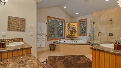 Primary king ensuite with tub, shower and his/her sinks