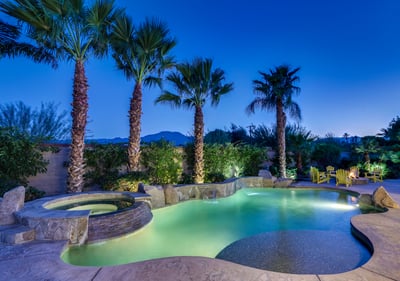 Large pool with tanning shelf and calming waterfalls