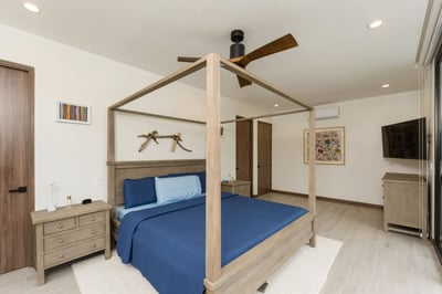 Relax in style with a cozy four poster bed, blue accents, and warm wood
Watch your favorite shows fr