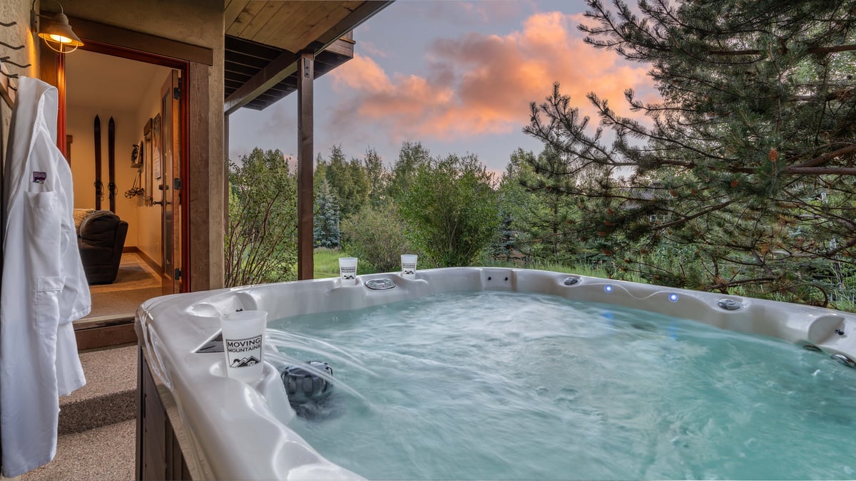 Soak in the private hot tub just steps away from the lower level family room - Image 21