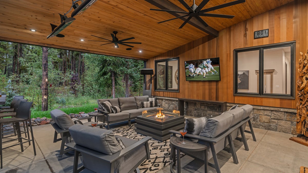 Covered back patio with plush seating, gas fireplace, and outdoor TV - Image 6