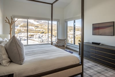 Wake up to breathtaking mountain vistas from your elegant four-poster bed, with floor-to-ceiling win