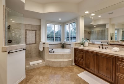 Primary en suite bath with two vanities, shower and jetted tub