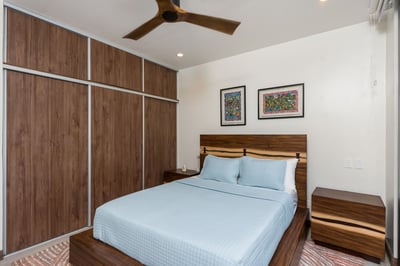 - Rest easy in a cozy room with a modern wood bed frame and serene blue bedding
- Enjoy colorful fra