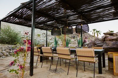 A beautiful covered outdoor dining and entertainment area with seating for 10 surrounded by spectacu